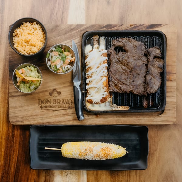 Don Bravo Mexican Grill's carne asada, enchiladas, rice, guacamole, pico de gallo, and elote.